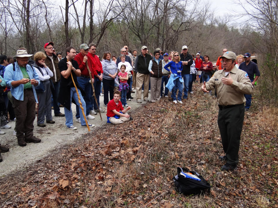 This Jan. 1, 2012 photo provided by the Virginia State Parks and the Department of Conservation and Recreation shows Virginia State Parks ranger Bob Flippen, right, at Virginia’s High Bridge Trail State Park leading a group of hikers on a First Day Hike in Va. The hike was one of 400 First Day Hikes held at state parks last Jan. 1. More than 600 are planned for this Jan. 1. (AP Photo/Virginia Department of Conservation and Recreation)