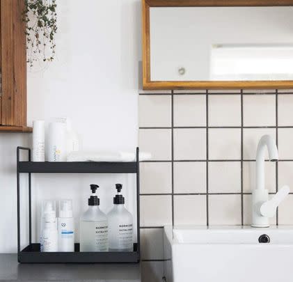 Use a tiered organiser to keep the bathroom countertop clear