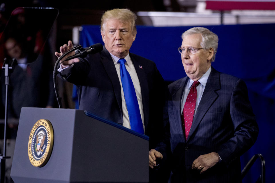 President Donald Trump, left, invites Senate Majority Leader Mitch McConnell of Ky., right, onstage as he speaks at a rally at Alumni Coliseum in Richmond, Ky., Saturday, Oct. 13, 2018. (AP Photo/Andrew Harnik)