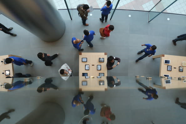 Chinese customers look at the iPad in the newly opened Apple Store (Photo by Feng Li/Getty Images)