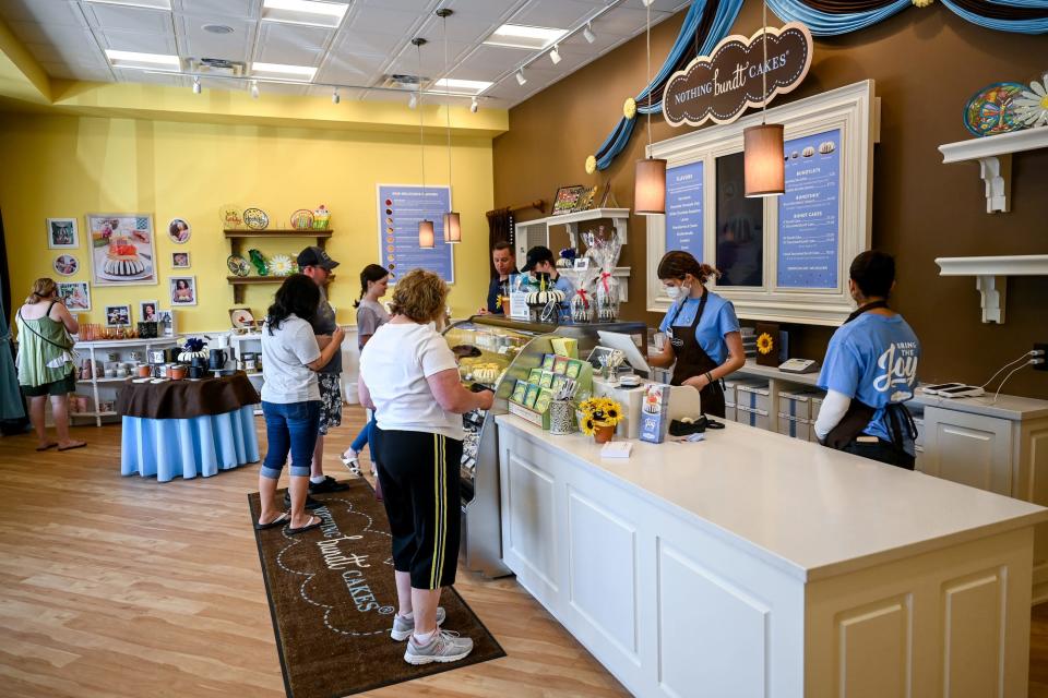Customers shop at Nothing Bundt Cakes on Thursday, June 16, 2022, at the new location in Okemos.