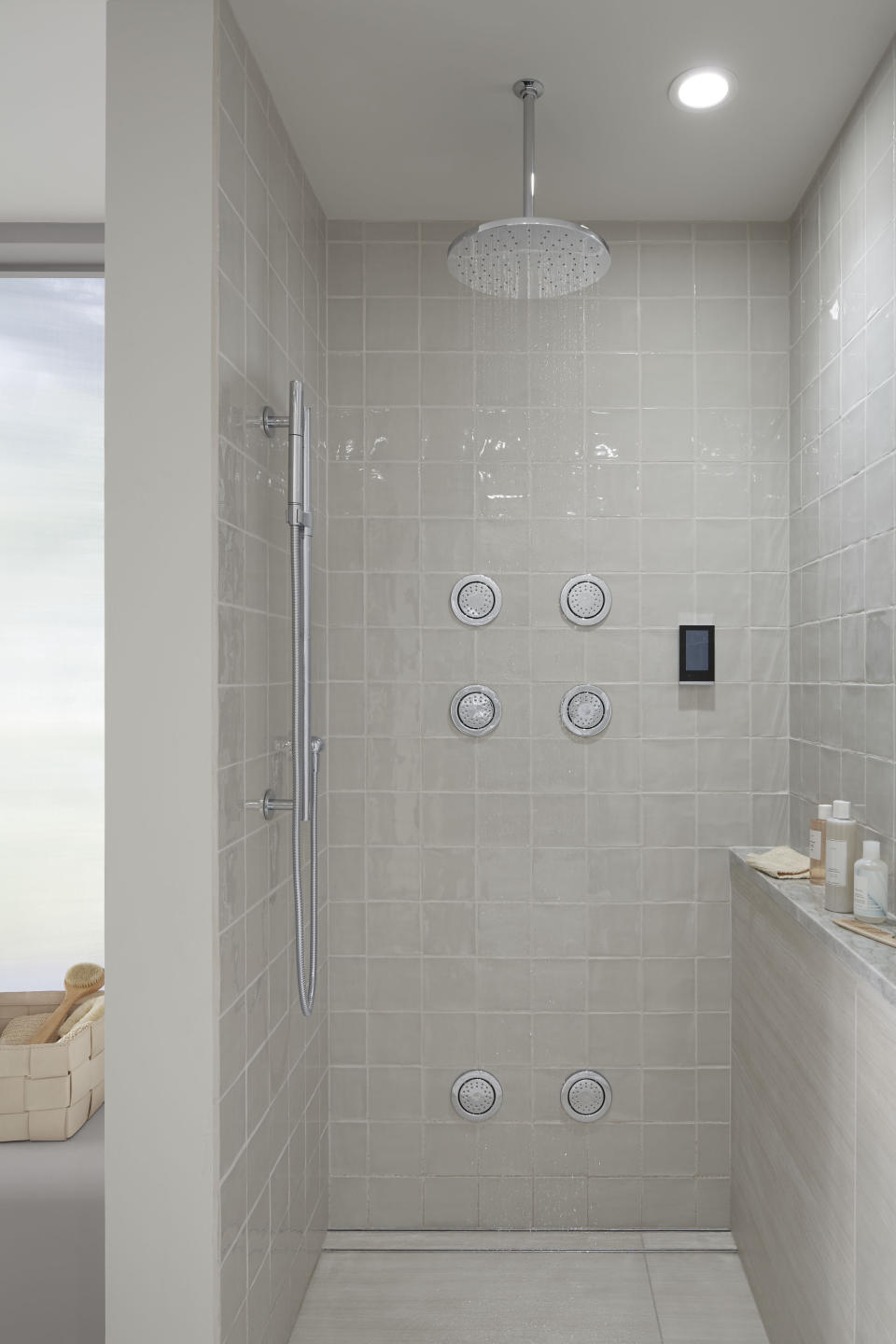 This photo provided by Kohler Co. shows Kohler's DTV+ system. The system brings water, steam, sound and light to the bath for a multi-sensory shower experience that incorporates a touchscreen interface and six user preset options to customize all four elements. (Kohler Co. via AP)