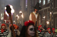 One man dressed as Guy Fawkes was held aloft during the parade (PA)