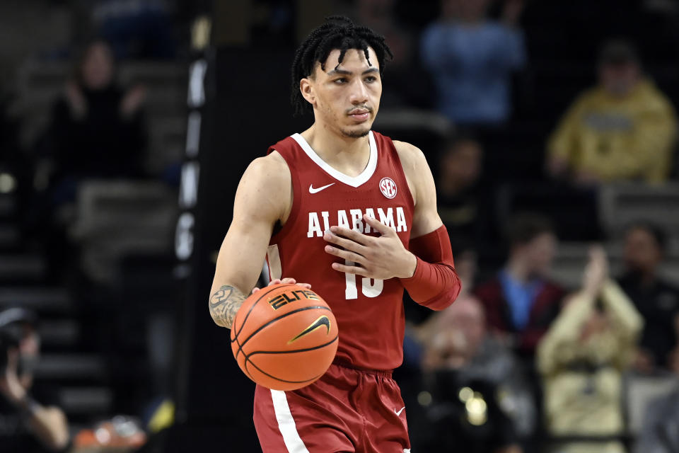 FILE - Alabama guard Jahvon Quinerly (13) plays against Vanderbilt during the second half of an NCAA college basketball game on Feb. 22, 2022, in Nashville, Tenn. Alabama must replace three of its top four scorers, and No. 2 scorer Quinerly is out for the start of the season recovering from knee surgery. Head coach Nate Oats is hoping to have him back by late December. (AP Photo/Mark Zaleski, File)