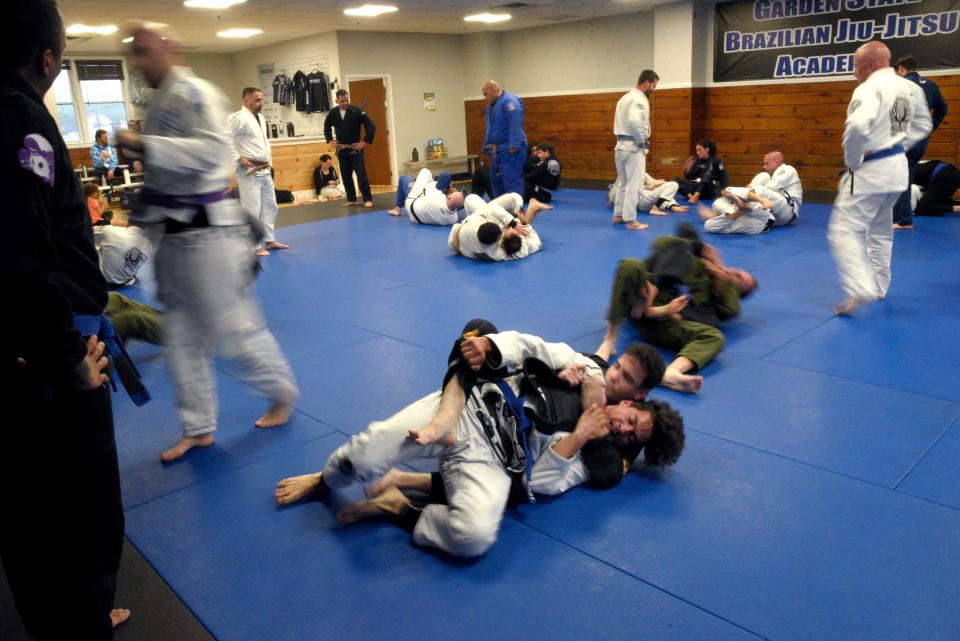 Reed Jeschonek, 32, left, holds Alex Roman, 46, as Roman attempts a back escape at the Garden State Brazilian Jiu-Jitsu Academy on Wednesday, June 7, 2023 in Middletown, New Jersey. 