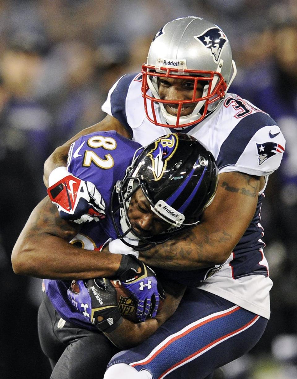 FILE - In this Dec. 22, 2013 file photo, Baltimore Ravens wide receiver Torrey Smith (82) is tackled by New England Patriots cornerback Aqib Talib in the second half of an NFL football game, in Baltimore. The Broncos spent the first day of free agency bolstering their defensive backfield, agreeing to a four-year deal with Pro Bowl safety T.J. Ward on Tuesday afternoon, March 11, 2014, and then hours later reaching an agreement on a six-year contract with cornerback Aqib Talib.(AP Photo/Nick Wass)