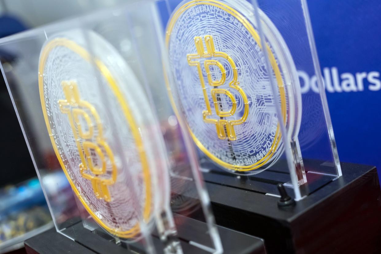 The Bitcoin logo on souvenirs during the listing ceremony for the CSOP Bitcoin Futures and CSOP Ether Futures exchange-traded funds (ETFs) at the Hong Kong Stock Exchange in Hong Kong, China, on Friday, Dec. 16, 2022. Photographer: Paul Yeung/Bloomberg