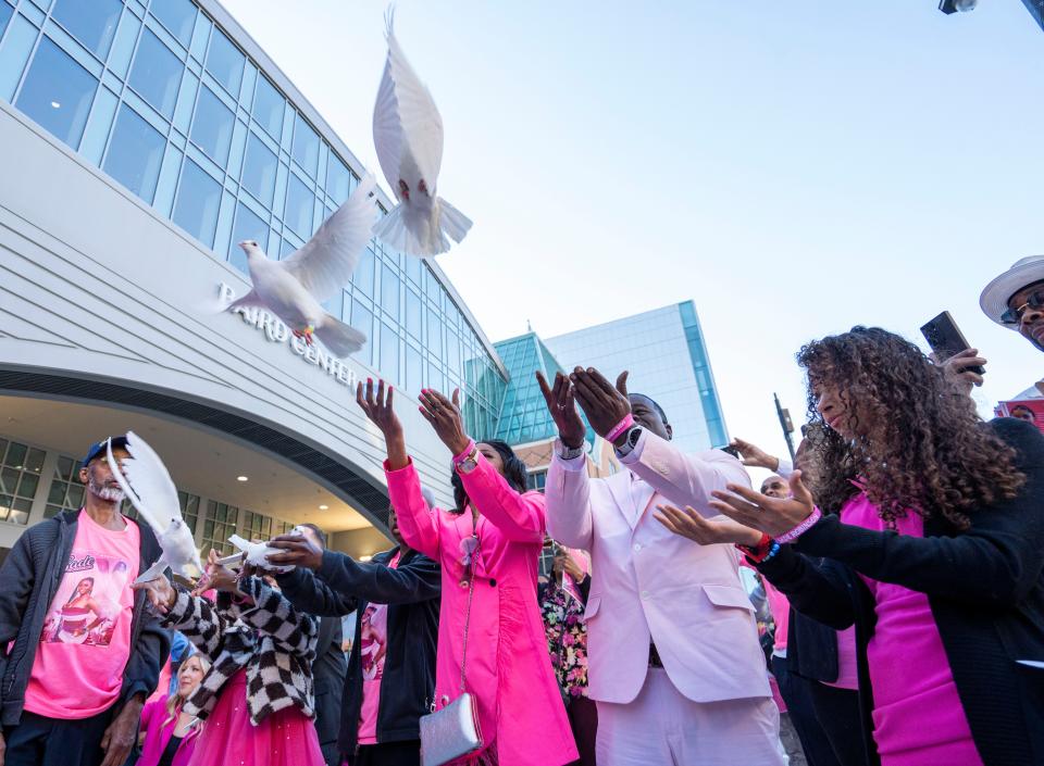 Sheena Scarbrough, center from left, mother of Sade Robinson; Carlos Robinson, father of Sade Robinson; and Adrianna Reams, sister of Sade Robinson, release doves in memory Sade Robinson at her public memorial service Friday at the Baird Center in Milwaukee.