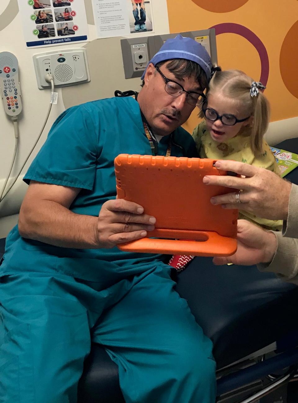 Dr. Richard Hertle with Holly Christensen's daughter, Lyra, who’s wearing Miraflex frames, in 2018 before she had a procedure under general anesthesia at Akron Children's Hospital.