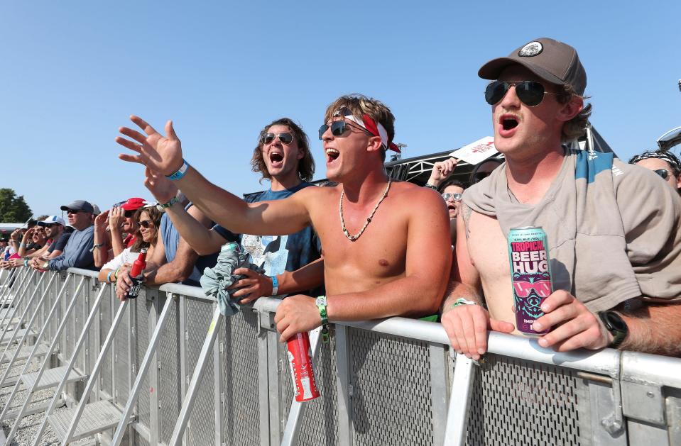 (R-L) Liam Oakes, Justen Betcher, and his cousin Brad Betcher sang along as they watched Shakey Graves perform on the Oak stage at Bourbon and Beyond in Louisville, Ky. on Sept. 15, 2022.  