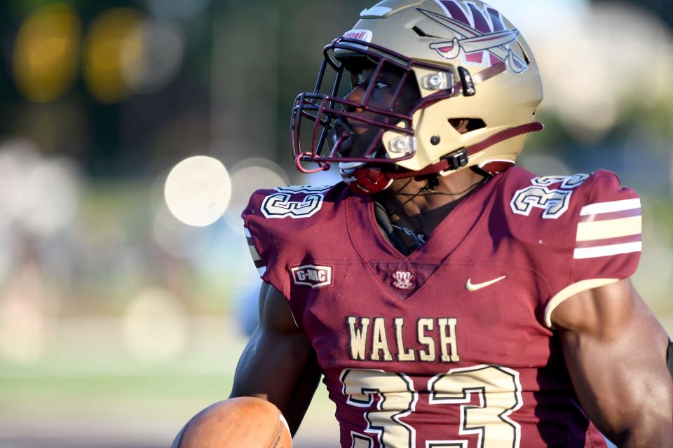 Walsh running back Dom Jennings scores a touchdown in the first quarter of Thursday's season opener against West Liberty.