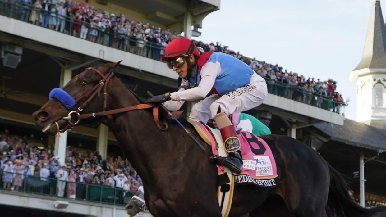 John Velazquez riding Medina Spirit crosses the finish line to win the 147th running of the Kentucky Derby at Churchill Downs.