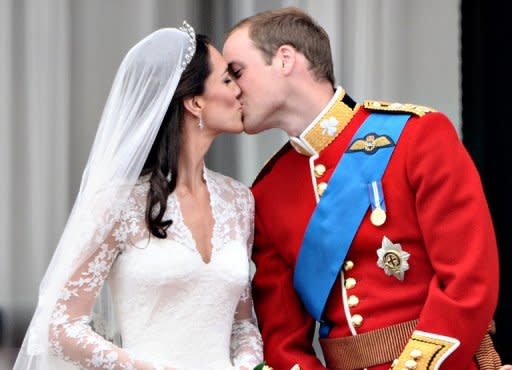 Prince William kisses his wife Catherine, Duchess of Cambridge, on the balcony in Buckingham Palace after their wedding service in April 2011. Their wedding was watched on television by up to two billion people around the world