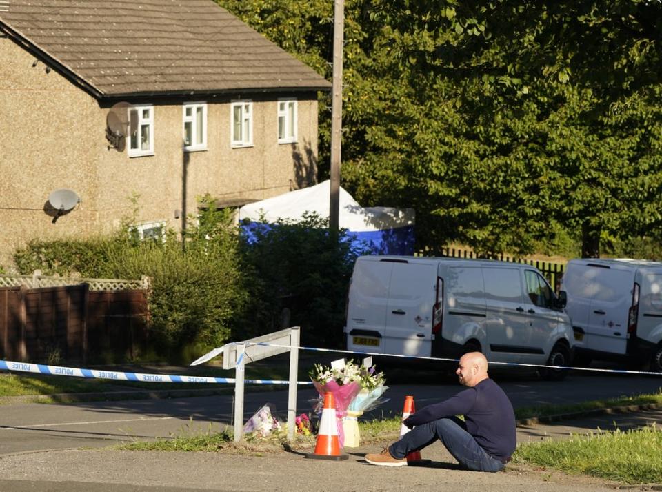 The father to some of the victims leaves flowers at the scene in Chandos Crescent, Killamarsh, near Sheffield, where four people were found dead at a house on Sunday. Derbyshire Police said a man is in police custody and they are not looking for anyone else in connection with the deaths. Picture date: Monday September 20, 2021. (PA Wire)