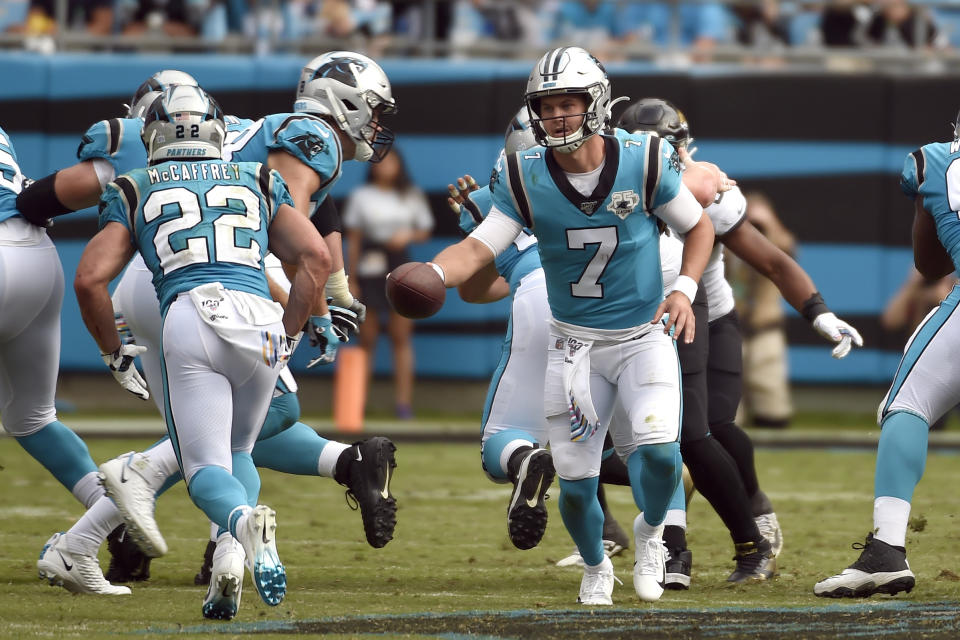 Carolina Panthers quarterback Kyle Allen (7) hands off to running back Christian McCaffrey (22) during the second half of an NFL football game in Charlotte, N.C., Sunday, Oct. 6, 2019. (AP Photo/Mike McCarn)