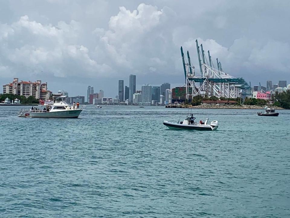 A coast guard boat, far right, turns back boats from the PortMiami channel after the Fisher Island ferry was struck by a boat early Sunday morning, which caused PortMiami to close.