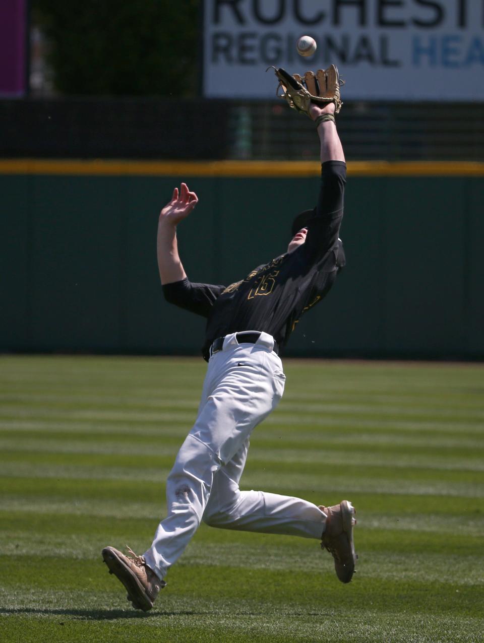 HF-L second baseman Conor Finn makes a catch as he falls backwards in shallow right field to put out Sutherland's Owen Osborne in the first inning.