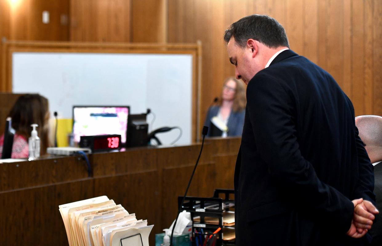 Assistant District Attorney Michael Luzzo reads from facts of the arrest as Arnoldo Nogueira Filho, 19; Wallisom Texeira Da Silva, 20; and Pedro Desouza-Passos, 27, are arraigned individually behind a white board in Westborough District Court.