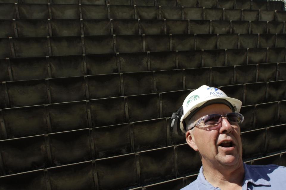 In this Sept. 12, 2012 photo, Brad Crookshank, wastewater superintendent for the Archer Daniels Midland company corn processing plant talks about the plant's water needs in Decatur, Ill. in front of the facility's water cooling towers. At the height of the 2012 drought, decision-makers at the agribusiness giant kept an uneasy eye on the reservoir down the hill from their headquarters. While companies in the Great Lakes region and other parts of middle America long counted on water being cheap and plentiful, they now realize they must conserve because finding new water sources is difficult and expensive - if it can be done at all. "You've got to plan for the worst, and be prepared for that," said Crookshank. "There's not a lot of low-hanging fruit for additional water supplies." (AP Photo/Seth Perlman)