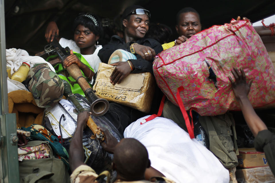 Seleka Muslim militias evacuate the Camp de Roux downtown Bangui, Central African Republic, Monday Jan. 27, 2014, to relocate and join other Selekas at the PK11 camp.The clearing out of Camp de Roux — normally the army's main base in the capital — comes more than two weeks after rebel leader-turned-president Djotodia surrendered power amid mounting international condemnation of his inability to stop sectarian bloodshed. A new interim civilian government has pledged to halt the violence and attempt to organize elections no later than February 2015. (AP Photo/Jerome Delay)