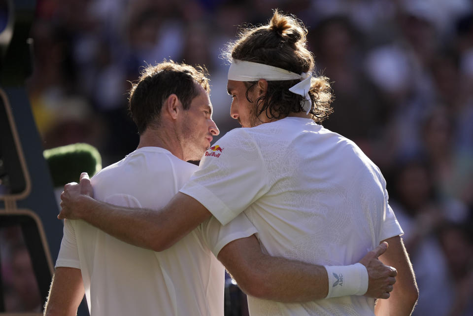 Stefanos Tsitsipas of Greece, right, greets Britain's Andy Murray at the net after beating him in a men's singles match on day five of the Wimbledon tennis championships in London, Friday, July 7, 2023. (AP Photo/Alberto Pezzali)