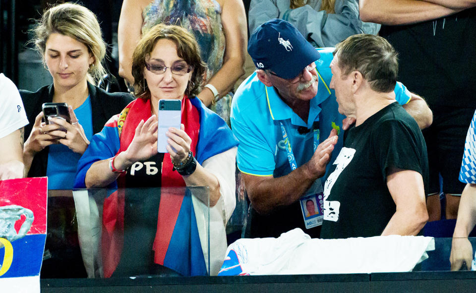 A security guard, pictured here talking to a fan wearing a shirt with the 'Z' symbol at the Australian Open.