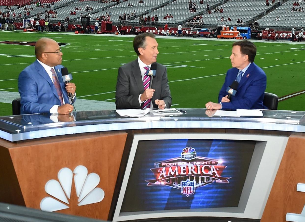 Sunday Night Football commentators Mike Tirico, Cris Collinsworth and Bob Costas report prior to the NFL game between the New England Patriots and Arizona Cardinals at University of Phoenix Stadium on September 11, 2016 in Glendale, Arizona. Collinsworth attended Astronaut High in Titusville before playing with the Florida Gators and Cincinnati Bengals.