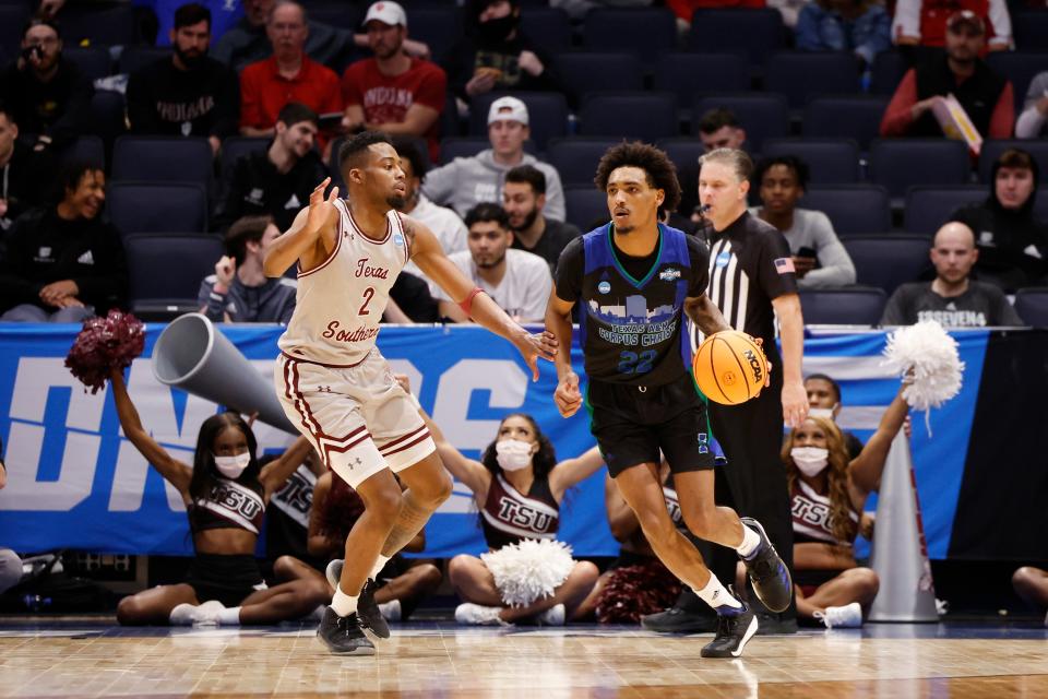 Mar 15, 2022; Dayton, OH, USA; Texas A&M-CC Islanders guard Simeon Fryer (22) dribbles down court defended by Texas Southern Tigers guard AJ Lawson (2) in the first half  during the First Four of the 2022 NCAA Tournament at UD Arena. Mandatory Credit: Rick Osentoski-USA TODAY Sports