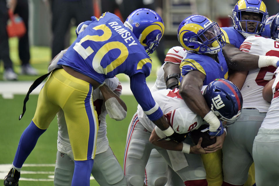 New York Giants quarterback Daniel Jones, center, is sacked by Los Angeles Rams cornerback Jalen Ramsey (20) during the first half of an NFL football game Sunday, Oct. 4, 2020, in Inglewood, Calif. (AP Photo/Jae C. Hong )