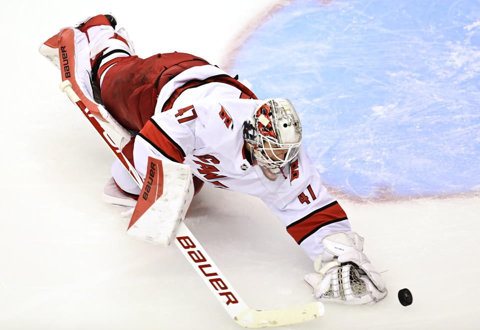 Carolina Hurricanes' goaltender James Reimer (47) reaches for a puck against the New York Rangers during second period NHL Eastern Conference Stanley Cup playoff action in Toronto on Tuesday, Aug. 4, 2020. (Frank Gunn/The Canadian Press via AP)