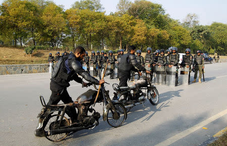 Police retrieve their motorcycles which were burned during clashes with protesters near the Faizabad junction in Islamabad, Pakistan November 26, 2017. REUTERS/Caren Firouz