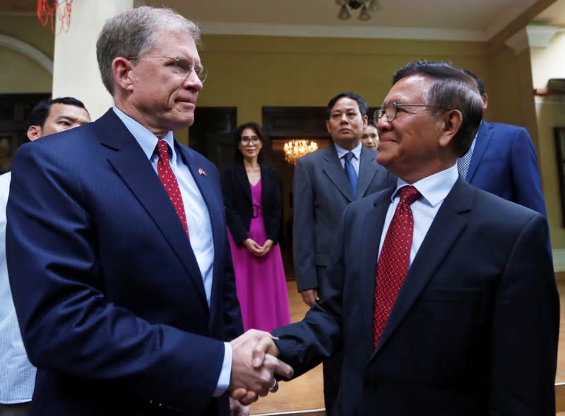 Leader of the Cambodia National Rescue Party (CNRP) Kem Sokha shakes hands with the U.S Ambassador to Cambodia Patrick Murphy before a meeting at Sokha's home in Phnom Penh