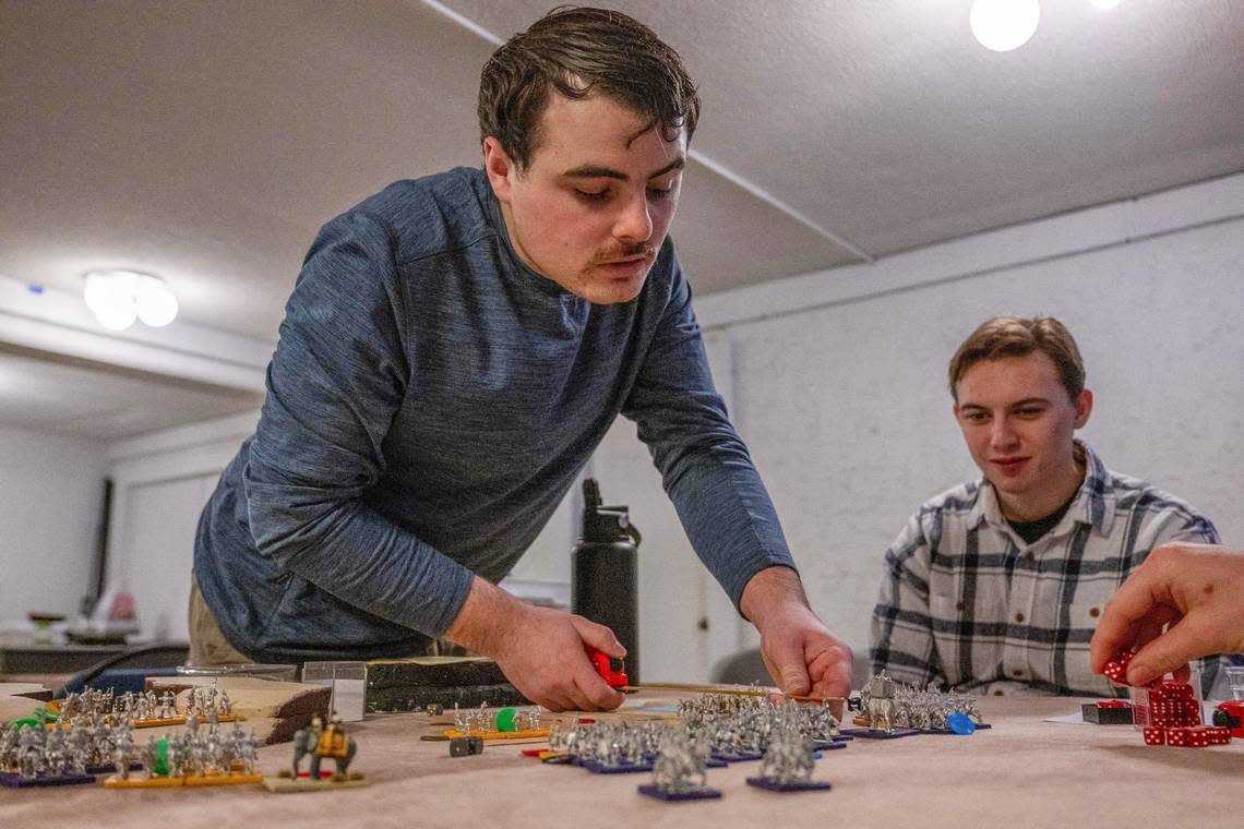 Scott Broyles, 23, leader of the Blemmye army, ancient soldiers from Africa, calculates dice rolls against his foe as part of the Baker University class, “Get the Lead Out: Understanding History Through Tabletop Wargaming.”
