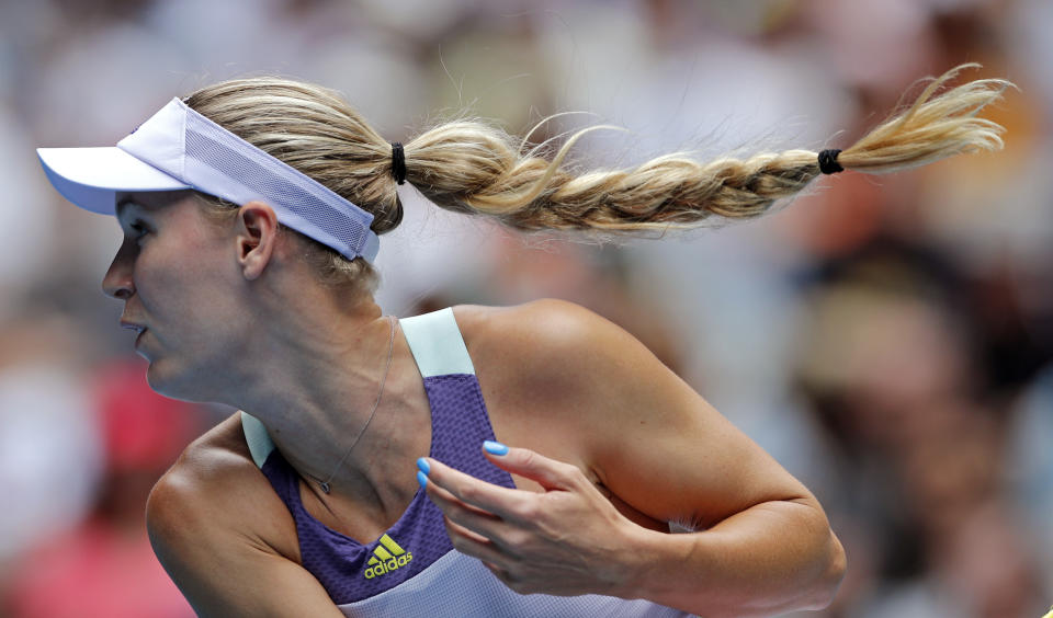 Denmark's Caroline Wozniacki serves to United States' Kristie Ahn during their first round singles match at the Australian Open tennis championship in Melbourne, Australia, Monday, Jan. 20, 2020. (AP Photo/Andy Wong)