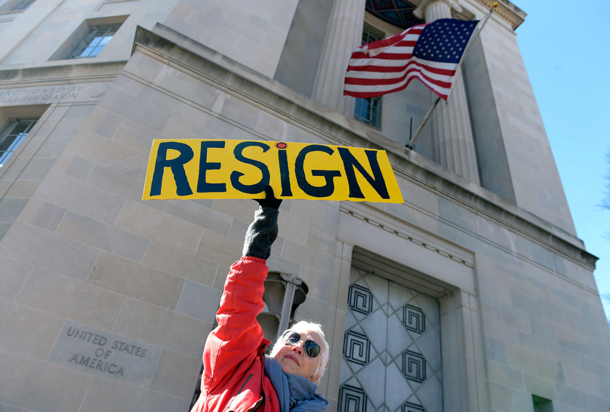 Cheryl Kreiser of Silver Spring, Md. holds up a sign outside Justice Department in Washington, Thursday, March 2, 2017, as she joined a group to protest Attorney General Jeff Sessions. (Photos: Susan Walsh/AP)