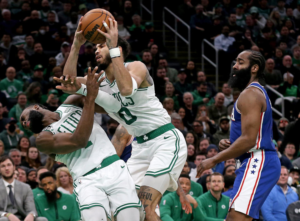 Jayson Tatum of the Boston Celtics collides with Jaylen Brown