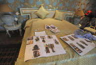 Photographs of models are spread on a bed during a shoot for the Lotus Make-up India Fashion Week, at the farmhouse of a designer in New Delhi, India, Friday, Oct. 2, 2020. Unlike a fashion show, models aren't swaying live on a ramp. They are depending on digital technology to rescue their annual extravaganza from the coronavirus pandemic with ''Phygital edition." India’s first digital fashion week is being held from Oct. 14-18, live streaming the spring-summer collections by more than 40 fashion designers. (AP Photo/Manish Swarup)