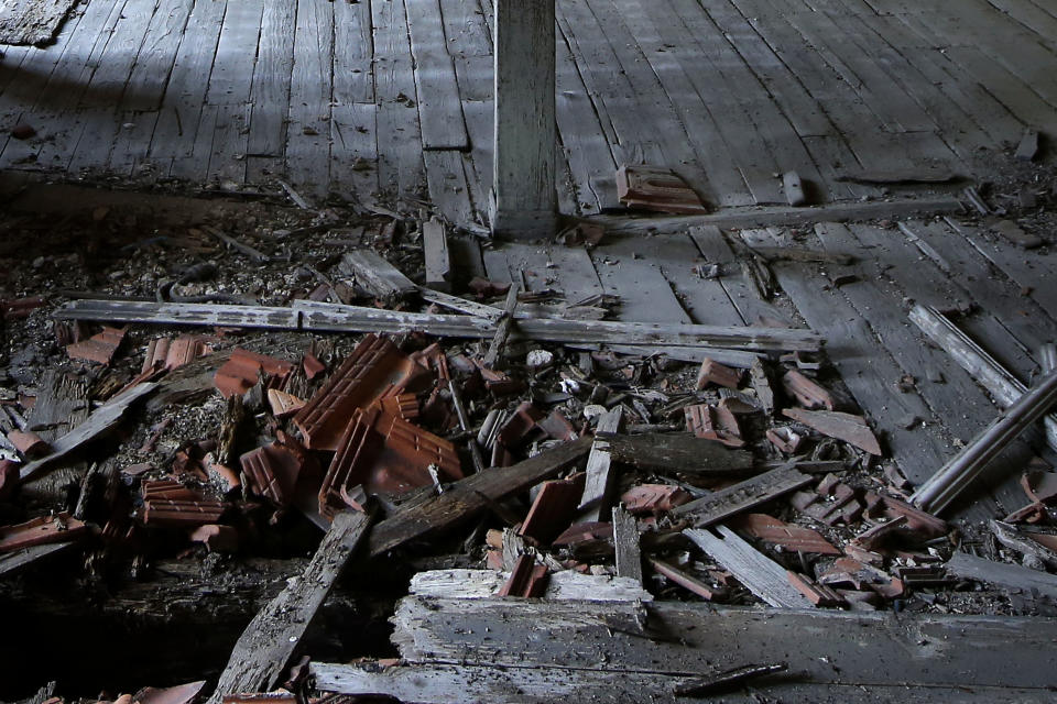 This Saturday, July 21, 2018 photo, shows a view of a damaged room inside the Prinkipo orphanage, a 6-floor timber building that once served as an orphanage for children of the minority Greek community, in Buyukada, the largest and most popular of the Princes' Islands in the Sea of Marmara near Istanbul. The 120-year-old gigantic building, occupying 20,000 square meters on a hilltop_ became home for some 5,800 minority Greek children from 1903 until 1964 when it was forced to shut down. (AP Photo/Lefteris Pitarakis)