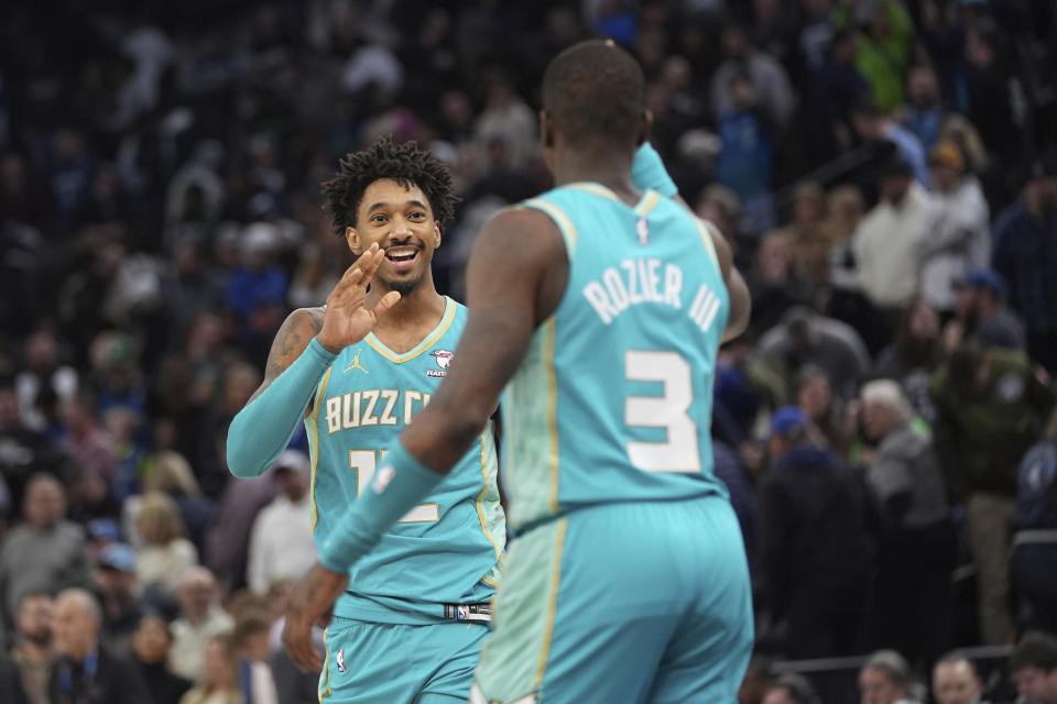 Charlotte Hornets forward Leaky Black, left, and guard Terry Rozier (3) celebrate after their win against the Minnesota Timberwolves in an NBA basketball game, Monday, Jan. 22, 2024, in Minneapolis. (AP Photo/Abbie Parr)