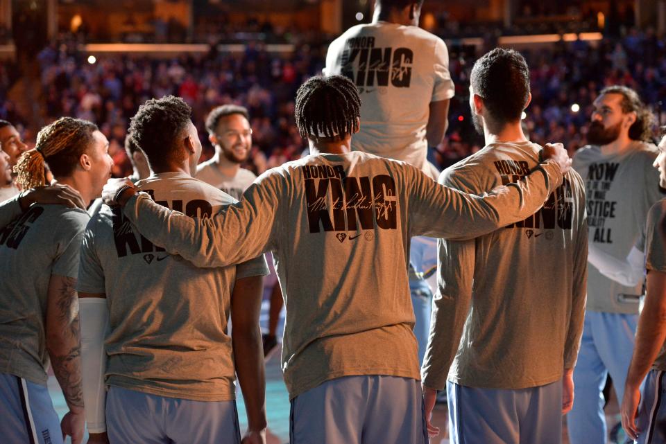 The Memphis Grizzlies stand on the court before an NBA basketball game against the Chicago Bulls on Martin Luther King Jr. Day, Monday, Jan. 17, 2022, in Memphis, Tenn. (AP Photo/Brandon Dill)