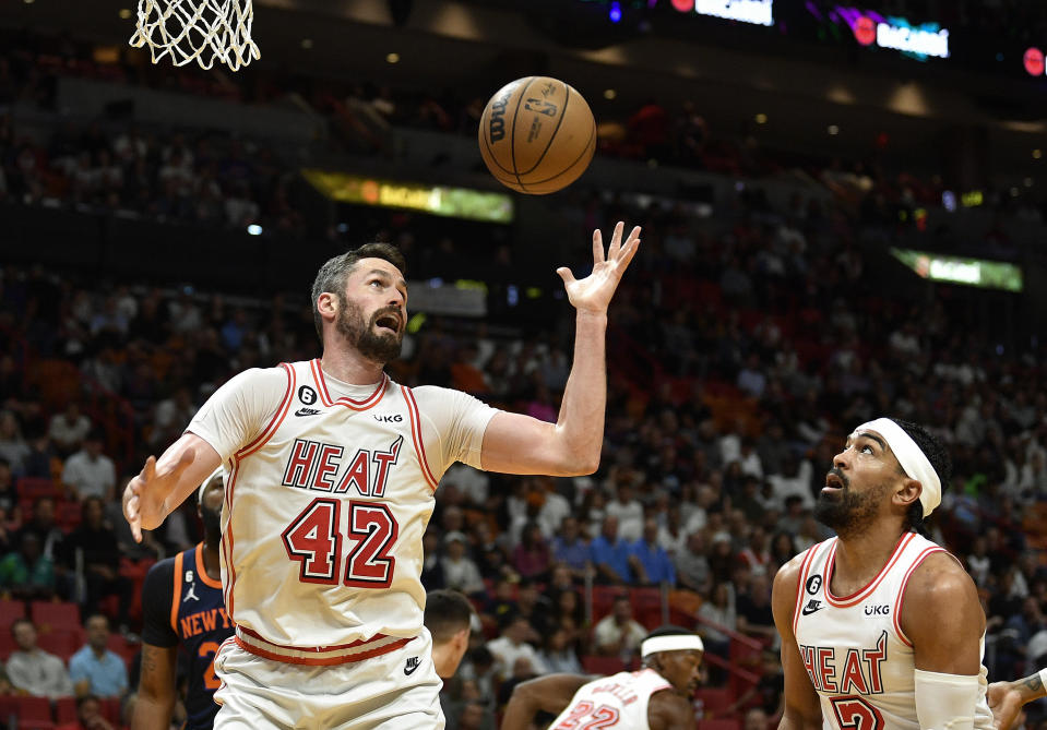 Miami Heat forward Kevin Love (42) grabs a rebound in front of teammate Gabe Vincent (2) during the first half of an NBA basketball game, Wednesday, March 22, 2023, in Miami, Fla. (AP Photo/Michael Laughlin)