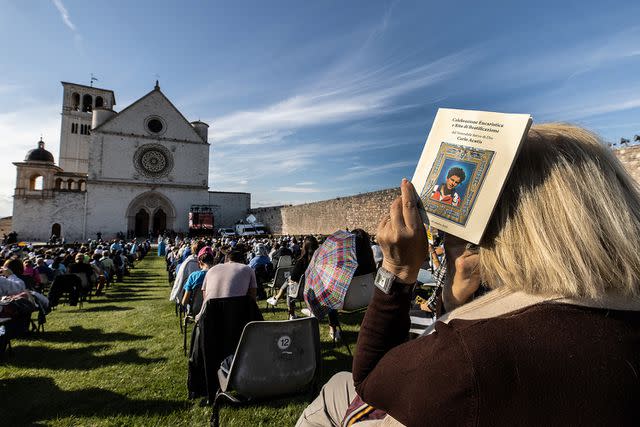 <p>Vatican Pool/Getty Images</p> People attend the beatification ceremony of Carlo Acutis at the St. Francis Basilica on October 10, 2020 in Assisi, Italy.