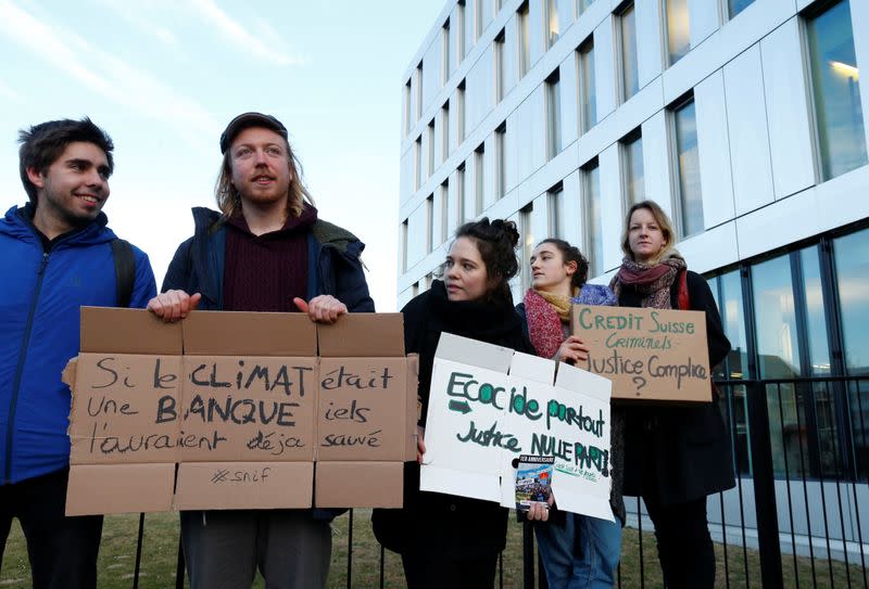 Activists protest outside the District Court of West Lausanne before the trial of twelve activists for a protest inside a branch of Credit Suisse bank in 2018 in Renens