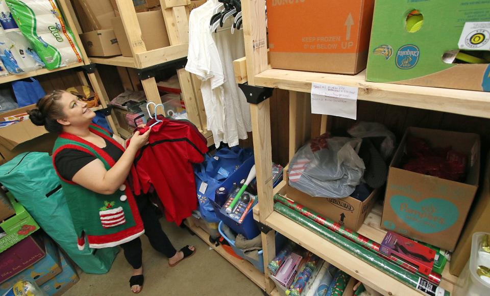 Executive Director Leah Hedgpath sorts clothing in the Christmas room Thursday morning, July 27, 2023, at the Dallas High Shoals Christian Ministry on East Trade Street in Dallas.