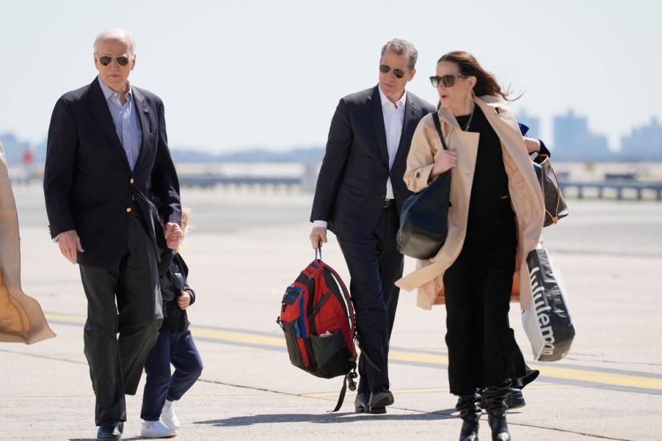 President Joe Biden walks with son Hunter Biden and daughter Ashley Biden as they walk to board Air Force One (AP)