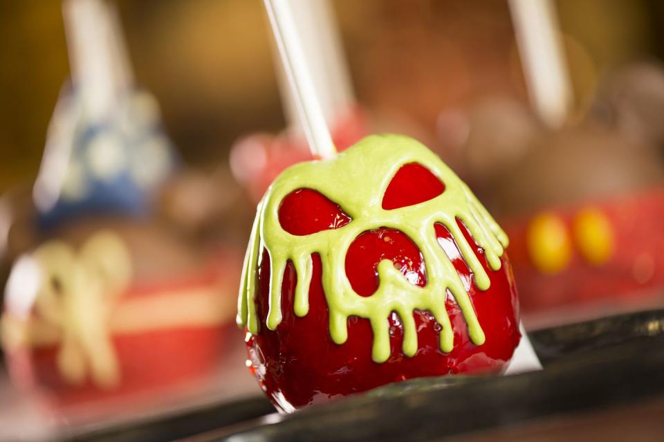 <p><a href="https://www.disneysprings.com/shopping/disneys-candy-cauldron/" rel="nofollow noopener" target="_blank" data-ylk="slk:Disney's Candy Cauldron;elm:context_link;itc:0;sec:content-canvas" class="link ">Disney's Candy Cauldron</a> first opened in 1997 and since then, it's become a staple stop for park-goers every Halloween. At the Cauldron, you can get literally every type of candy apple and watch them make it right in front of you. </p>