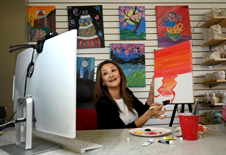 Mahsa Ghavamian, owner of Canvas n Cup in Westborough, teaches an an online acrylic painting class to a group of corporate customers, Nov. 19, 2021.