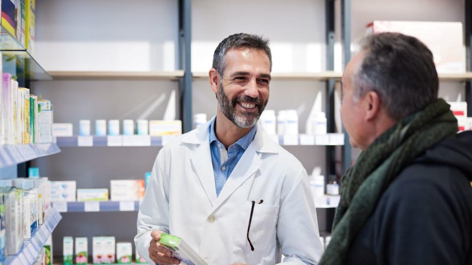 a pharmacist is attending a senior man