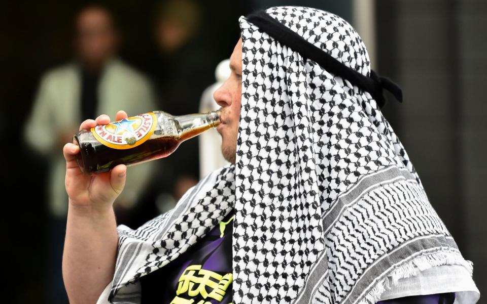 A fan of Newcastle outside the stadium before the English Premier League match - EPA-EFE/Shutterstock