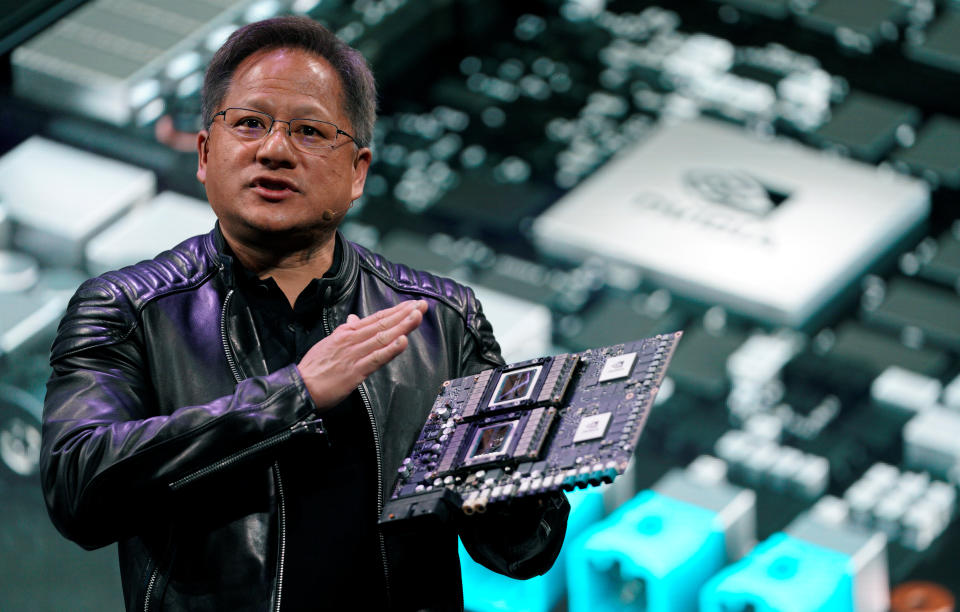 Jensen Huang, CEO of Nvidia, highlights an AI supercomputer at an event.